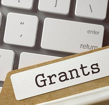 Grants folder on top of computer keyboard
