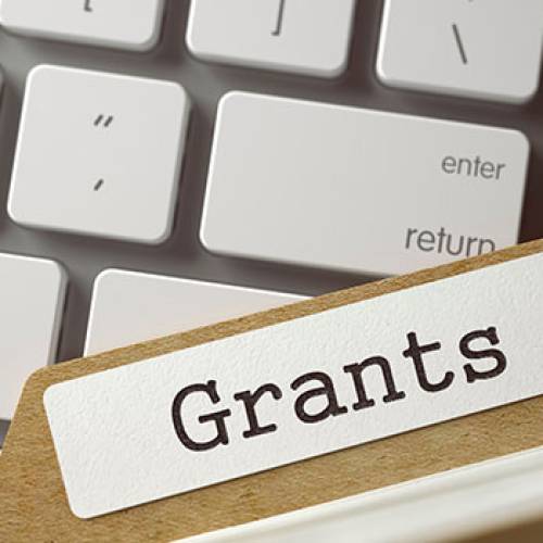 Grants folder over computer keyboard