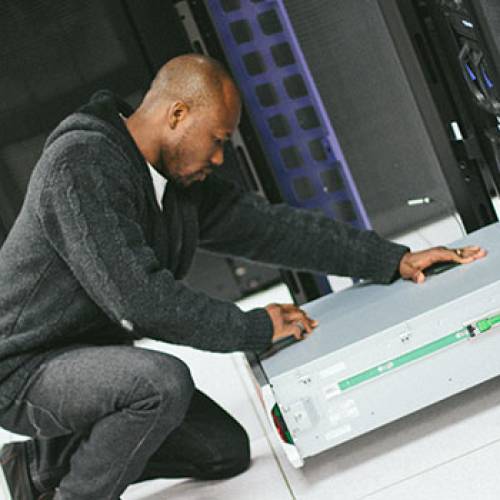 Man works on IT equipment