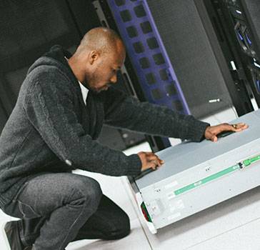 Man works on IT equipment