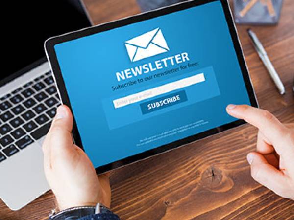 Person looking at an online newsletter on a tablet