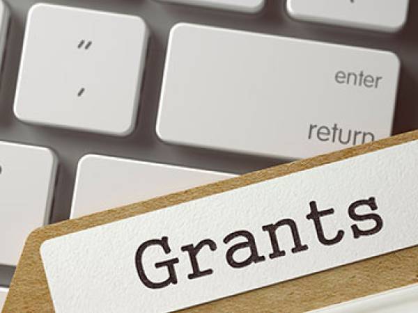 Grants folder over computer keyboard