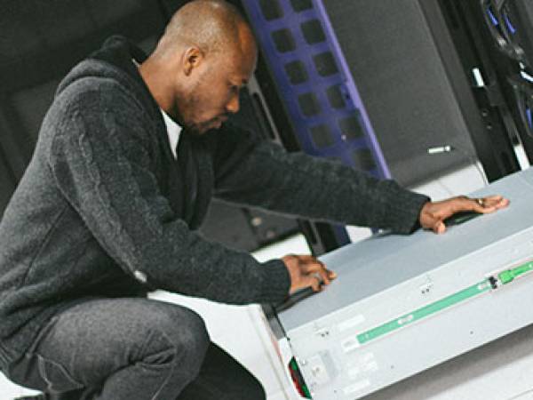 Man works on IT equipment