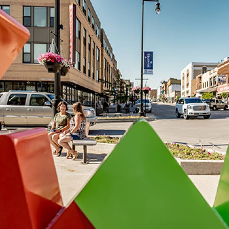 Downtown Minot, looking through the new Minot logo sculpture