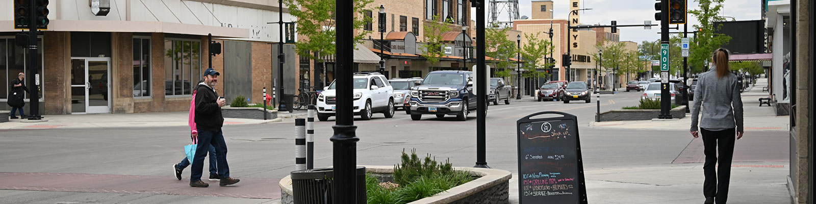 People walking in downtown Williston, which was recently renovated