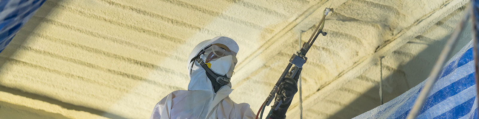 Spray insulation being applied to a building