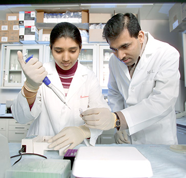 BioMedical student and professor testing a solution at UND