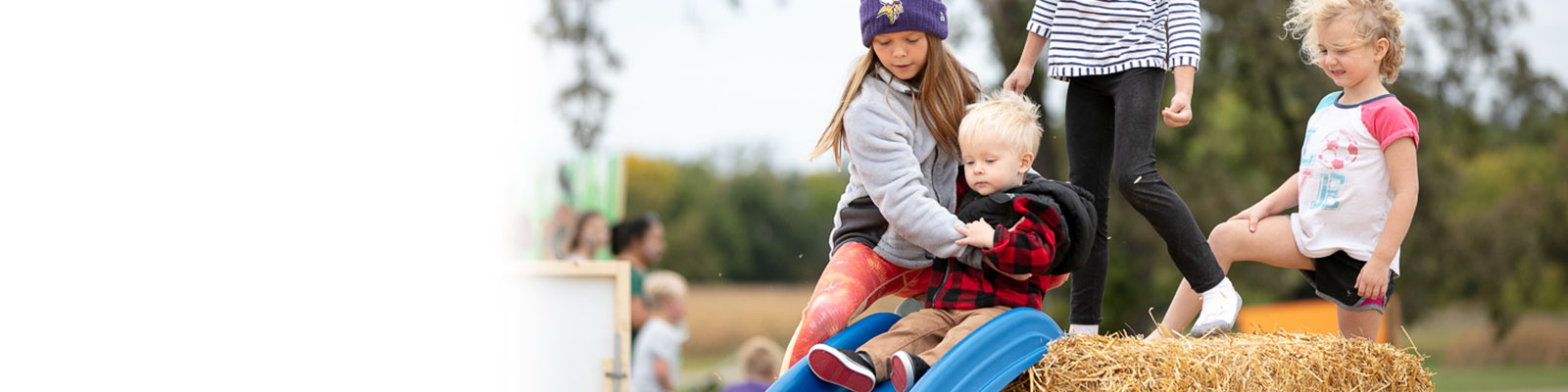 Kids playing at a fall harvest event