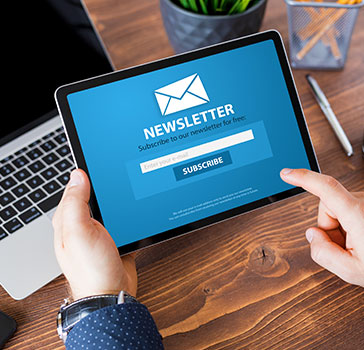 Person looking at an online newsletter on a tablet