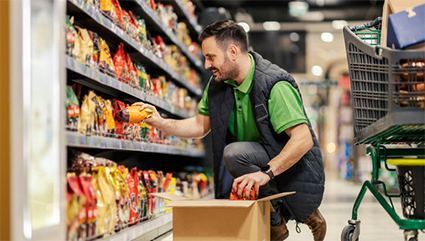 grocery store attendant stocking shelves