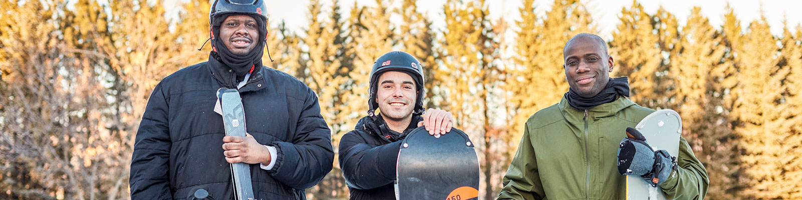 Multi-racial friends snowboarding at Frost Fire