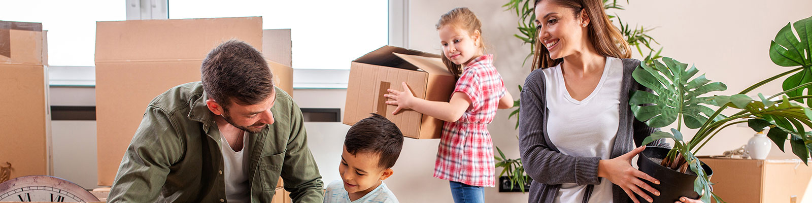 Family packing boxes to move