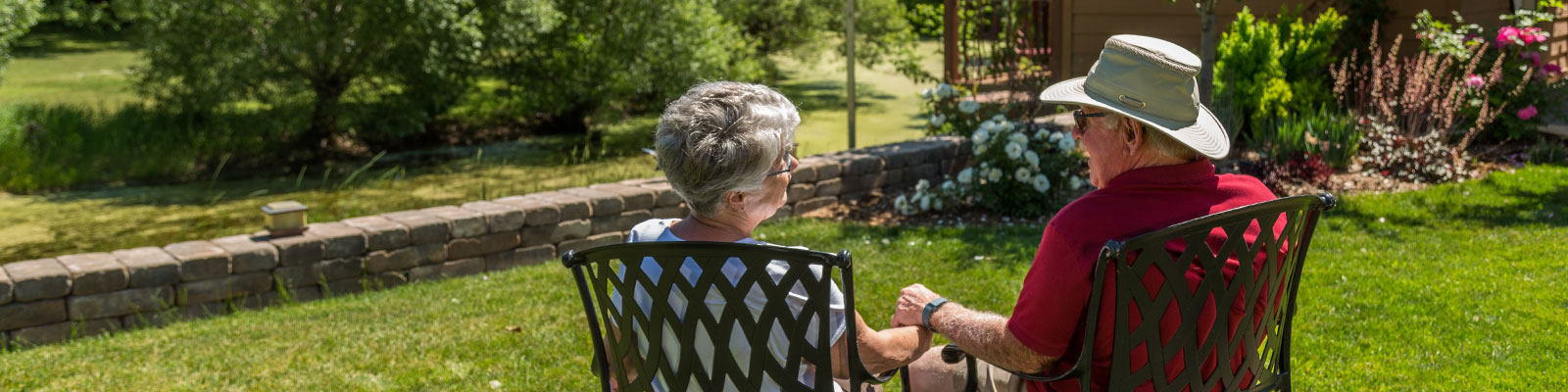 Retired couple relaxes in their backyard