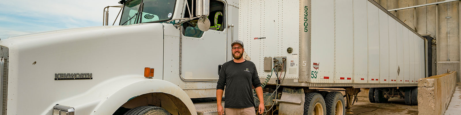 Driver stands in front of his commercial truck