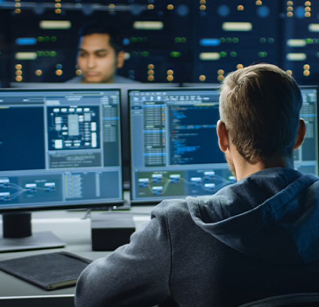 Technology workers writing code on computers