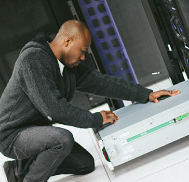 Man works on IT equipment